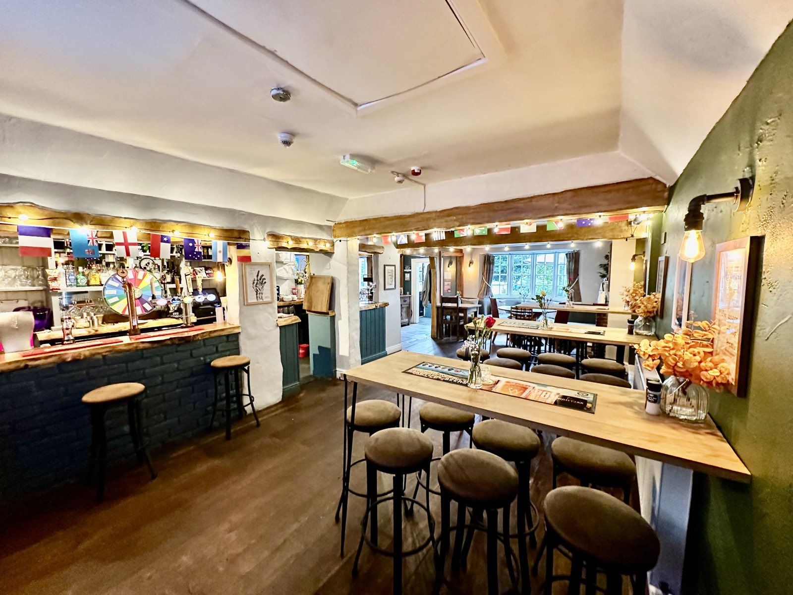Inside The Shakespeare Inn - the bar with festoon lights along the oak beams, high tables and stools.